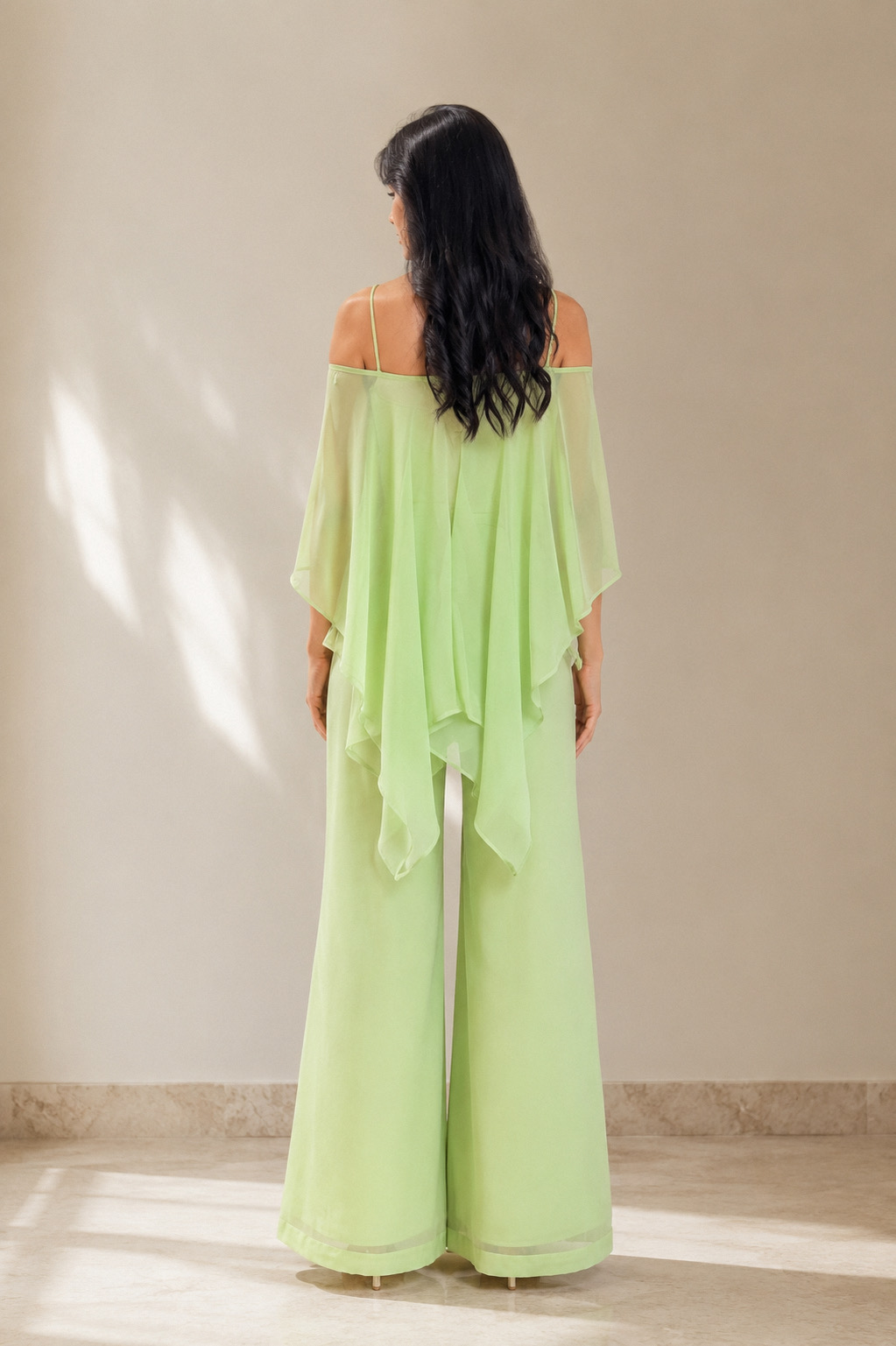 Back view of the Elara three piece cape kurti set showing the full cape fall and open-shoulder straps